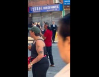 Man filming film crew with rooster on shoulder 