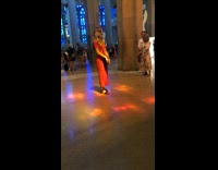 Girl in red dress poses in cathedral