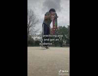 Guy practicing skateboard trick little kids watch him