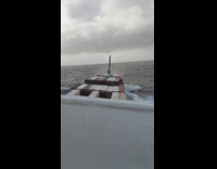 Cargo ship sails through the huge waves