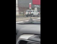 Man lie down on the hood of a car