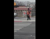 Guy juggles while crossing the crosswalk