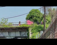 Dancer films video with pink smoke 