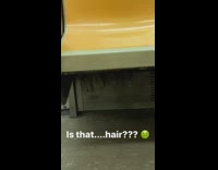 Strands of hair orange subway train seats 