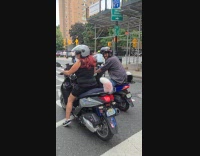 Two people on motorcycle with furry tails