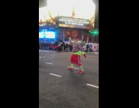 Guy in colorful clothes hold up soccer ball 
