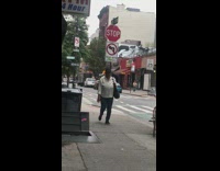 Guy rides box cargo cart likes scooter pushes with legs and rides down street