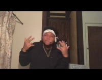 Guy sings and dances to hip hop song with nerf gun and dollar bills