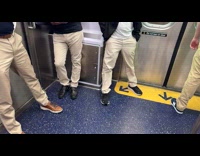 Four men wear khaki pants in train