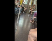 Woman sits on nice decor chair at the end of subway train