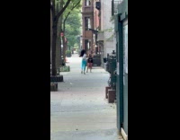 Woman blue pants tiktok dance on sidewalk
