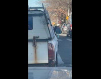 Rundown car has handheld mirror as side mirror