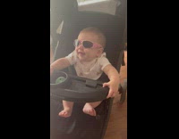 Baby with sunglasses in stroller 