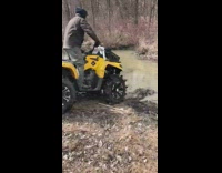 Yellow atv through deep mud black sweater