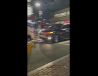 Lady wearing white dress struts and dances 