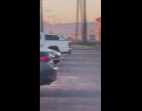 Old man beside car parking lot sunset