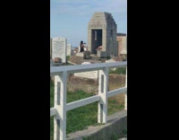 Woman bikini lie down tombstone cemetery photo shoot