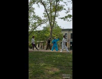 Four people practice with sword at park