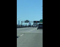 Car drives freeway white mattress on roof