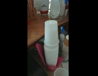 Plastic cup pushed down on the stack but slowly go up