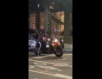 Man on motorcycle dressed as captain america