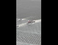Giant inflatable poop emoji on a barge in river
