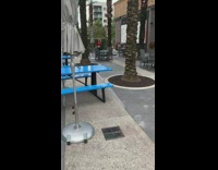 White shorts girl dances blue picnic tables 