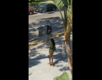 Woman green and yellow dress selfie tripod sidewalk