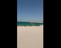 Woman bikini stand  log fence beach sunny