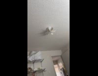 Man shows small ceiling fan in Airbnb