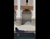 Woman lays down to take photo of friend 