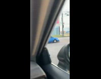 Small blue car street u turn