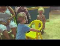 Little boy gets a chair for a girl