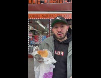 Guy promotes sandwich next to rapper 