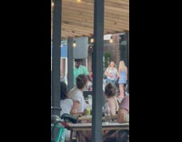 Man ride bike balance trash bin on head street