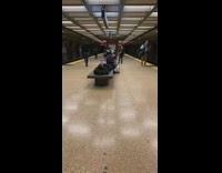 Guy lays on bench waiting for train
