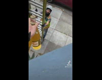 Woman offers construction worker bottle of drink