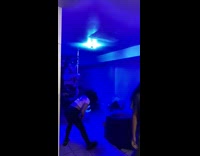 Guy and girl spin on stripple pole