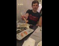 Guy struggles to pick up sushi chopsticks ends up ruining the sushi 
