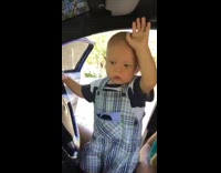 baby boy in blue dancing in car