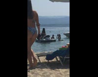 Woman black bikini rides on jet skit beach