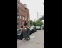 Couple wearing black ears poses against mailbox for photos 