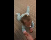 Baby reaches out for hand to stand up 