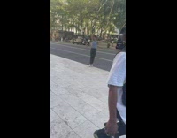 Woman does contemporary dance on sidewalk and street 