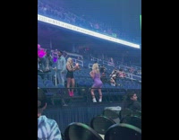 Two blonde girls pose on stairs concert