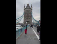 Kid take picture mom on bridge fence