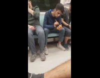 Guy uses pencil to write on orange 