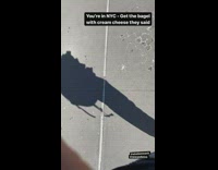 Guy shows bagel with square of cream cheese he got in nyc