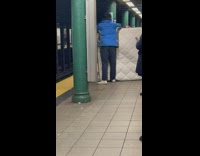 Man Holds Up Bed Mattress in Subway