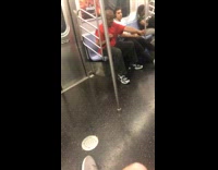 Man red shirt practices martial arts punch on subway train